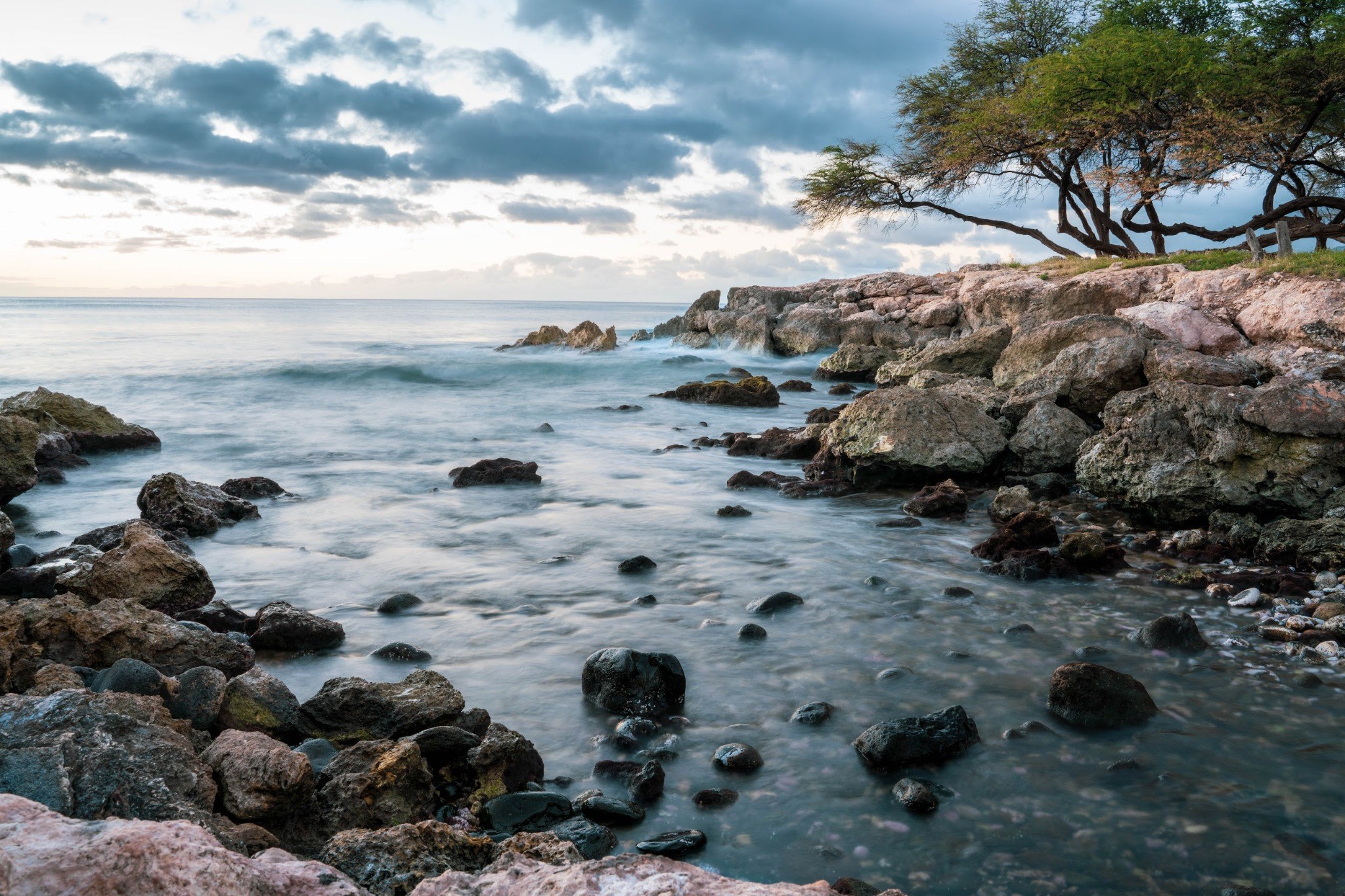 Ocean water moving through dark tidal rocks
